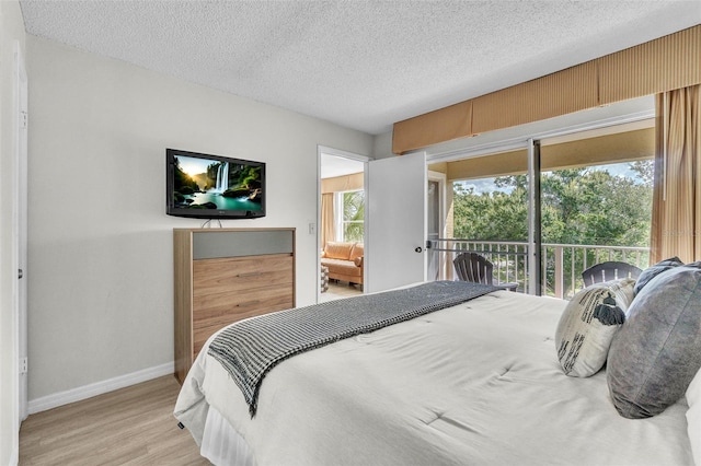 6337 Parc Corniche Dr Unit 2312, Orlando, FL 32821 - bedroom with light wood finished floors and a textured ceiling