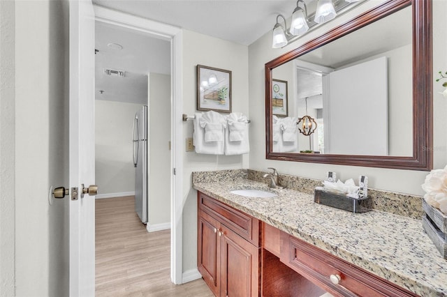 6337 Parc Corniche Dr Unit 2312, Orlando, FL 32821 - bathroom featuring vanity and wood finished floors