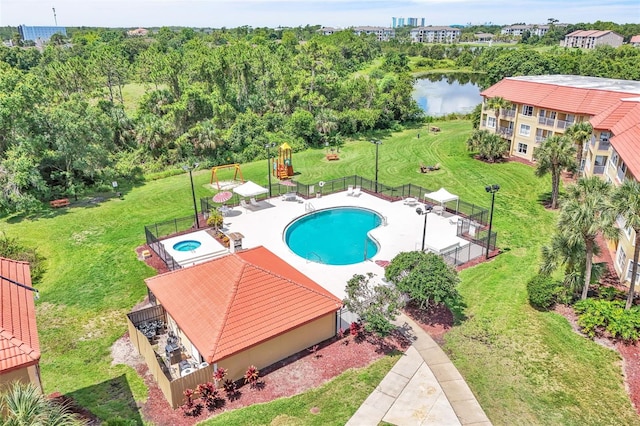 6337 Parc Corniche Dr Unit 2312, Orlando, FL 32821 - community pool with a water view, a hot tub, and a patio area