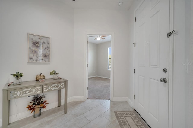 921 Costa Mesa Ln, Kissimmee, FL 34744 - foyer entrance featuring light tile patterned floors, light carpet, baseboards, and a ceiling fan