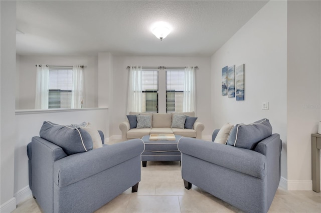 921 Costa Mesa Ln, Kissimmee, FL 34744 - living area featuring plenty of natural light, baseboards, a textured ceiling, and light tile patterned floors