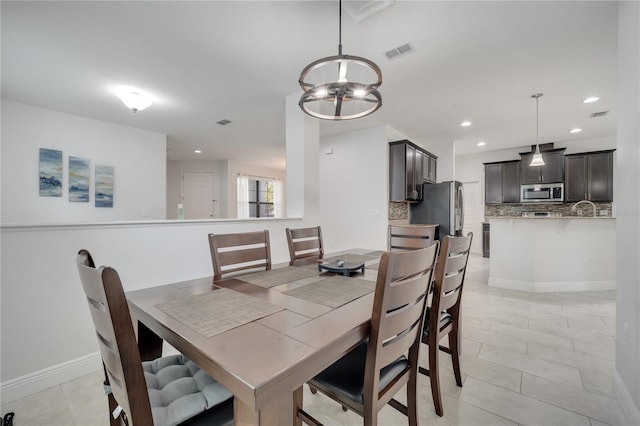 921 Costa Mesa Ln, Kissimmee, FL 34744 - dining space featuring recessed lighting, a chandelier, baseboards, and light tile patterned floors
