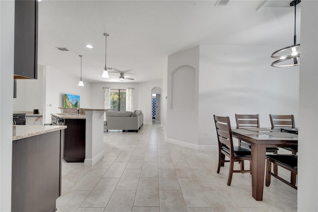 921 Costa Mesa Ln, Kissimmee, FL 34744 - dining room with arched walkways, a ceiling fan, baseboards, recessed lighting, and a chandelier