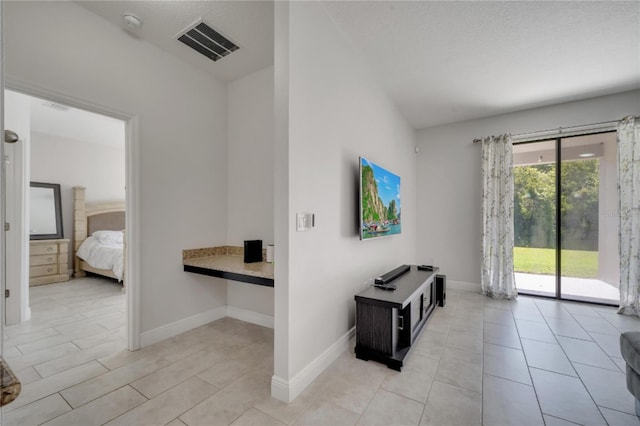 921 Costa Mesa Ln, Kissimmee, FL 34744 - unfurnished living room featuring baseboards and light tile patterned floors