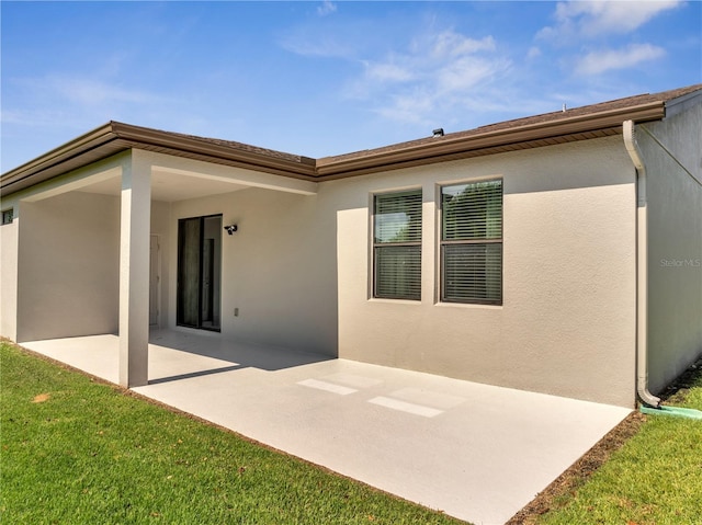 921 Costa Mesa Ln, Kissimmee, FL 34744 - rear view of property with a patio and stucco siding
