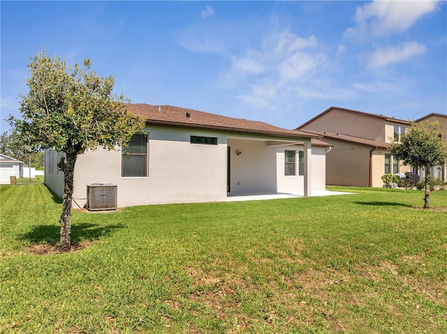 921 Costa Mesa Ln, Kissimmee, FL 34744 - back of house with a patio, central air condition unit, a yard, and stucco siding