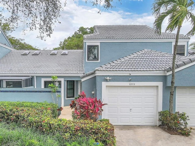 8353 Waterford Ave, Tamarac, FL 33321 - view of front of house featuring stucco siding, a tiled roof, driveway, and an attached garage