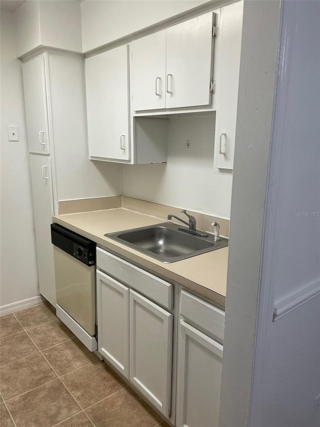315 Wymore Rd Unit 104, Altamonte Springs, FL 32714 - kitchen featuring dishwasher, a sink, baseboards, light countertops, and dark tile patterned floors