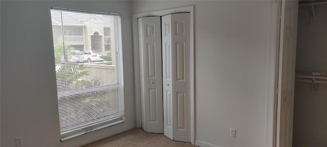 315 Wymore Rd Unit 104, Altamonte Springs, FL 32714 - unfurnished bedroom featuring light carpet and a closet