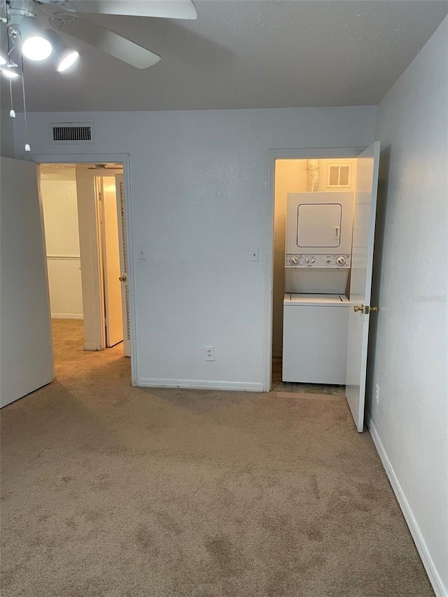 315 Wymore Rd Unit 104, Altamonte Springs, FL 32714 - carpeted spare room featuring stacked washer / drying machine, a ceiling fan, and baseboards