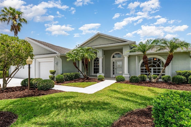 2135 Springwater Ln, Port Orange, FL 32128 - ranch-style house featuring stucco siding, a garage, a front lawn, and driveway
