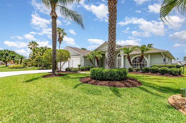2135 Springwater Ln, Port Orange, FL 32128 - view of front of property featuring a garage, concrete driveway, a front yard, and stucco siding