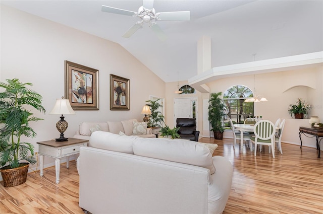2135 Springwater Ln, Port Orange, FL 32128 - living area with light wood-style flooring, vaulted ceiling, a ceiling fan, and baseboards