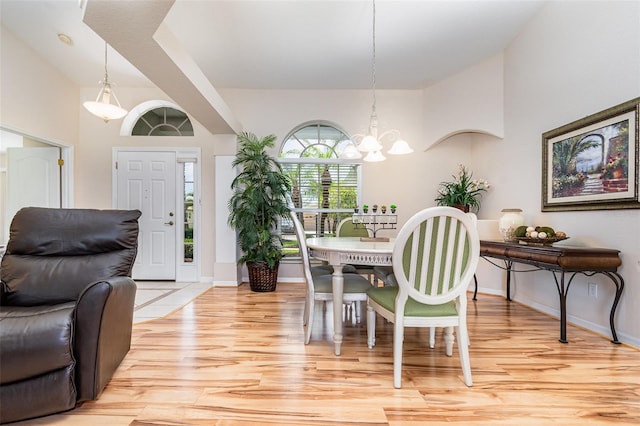 2135 Springwater Ln, Port Orange, FL 32128 - dining area with light wood-type flooring, a chandelier, and baseboards