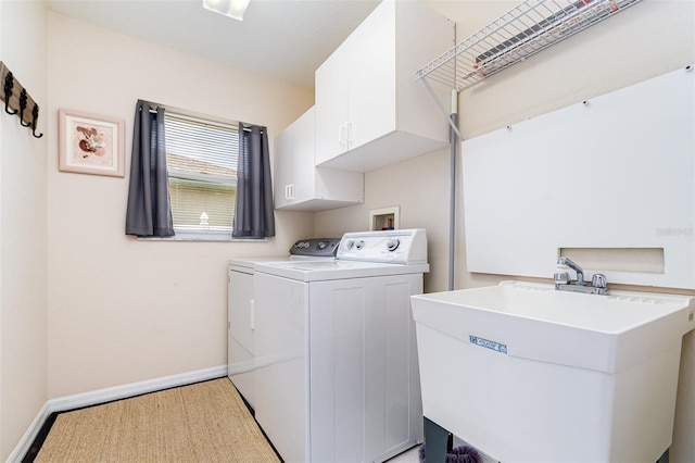 2135 Springwater Ln, Port Orange, FL 32128 - laundry area with cabinet space, washing machine and clothes dryer, and baseboards
