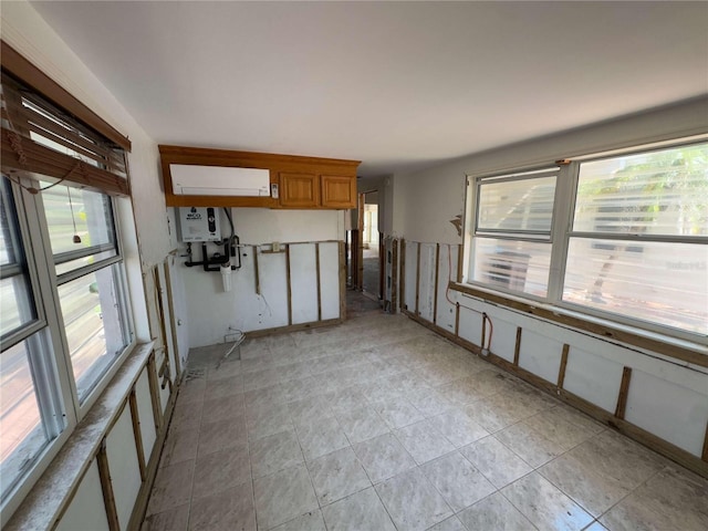 16107 Gulf Blvd, Redington Beach, FL 33708 - unfurnished living room featuring healthy amount of natural light and water heater
