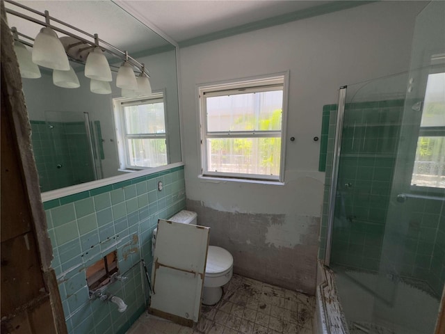 16107 Gulf Blvd, Redington Beach, FL 33708 - full bath with toilet, tile walls, tiled shower / bath, and wainscoting