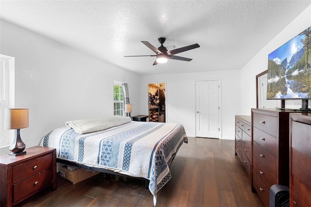 1805 Paloma Ave, Sanford, FL 32771 - bedroom with dark wood finished floors, a textured ceiling, a spacious closet, ceiling fan, and a closet