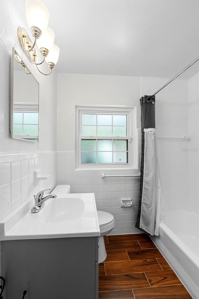 1805 Paloma Ave, Sanford, FL 32771 - full bath with tile walls, vanity, shower / bath combination with curtain, a chandelier, and wood finished floors