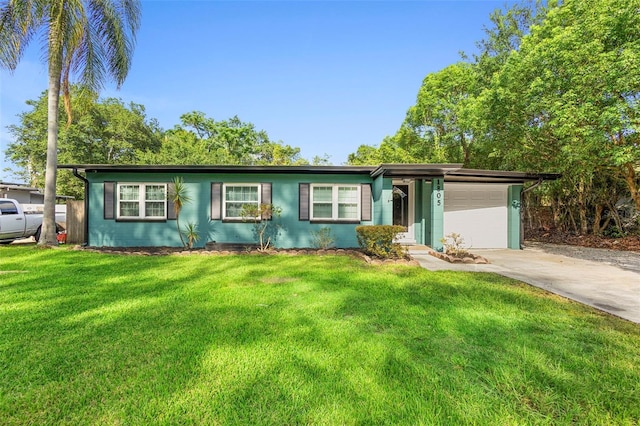 1805 Paloma Ave, Sanford, FL 32771 - view of front of property featuring concrete driveway, an attached garage, and a front yard