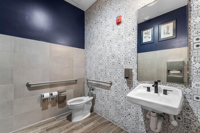 6615 Leo Ln, Saint Cloud, FL 34773 - half bathroom with tile walls, wood finished floors, and toilet