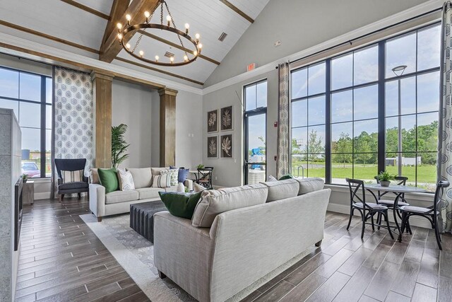 6615 Leo Ln, Saint Cloud, FL 34773 - living area with dark wood-type flooring, high vaulted ceiling, a chandelier, plenty of natural light, and baseboards