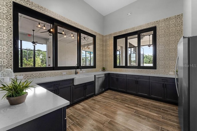 6615 Leo Ln, Saint Cloud, FL 34773 - bar area with appliances with stainless steel finishes, a sink, healthy amount of natural light, dark wood finished floors, and vaulted ceiling