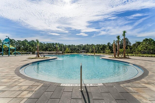 6615 Leo Ln, Saint Cloud, FL 34773 - community pool with view of scattered trees and a patio area