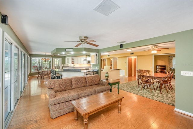 6321 Quarterhorse Cir, Cocoa, FL 32926 - living room with light wood-style floors, ceiling fan, and baseboards
