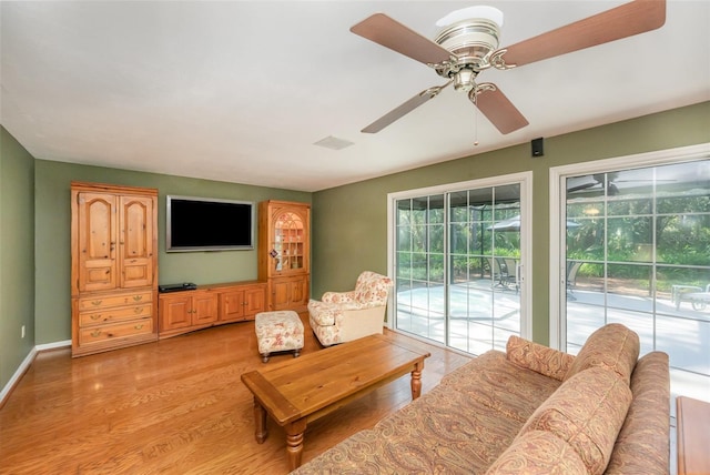 6321 Quarterhorse Cir, Cocoa, FL 32926 - living area with a ceiling fan, light wood-style floors, and baseboards