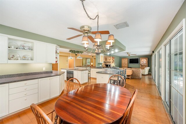 6321 Quarterhorse Cir, Cocoa, FL 32926 - dining room featuring ceiling fan, light wood-style floors, plenty of natural light, and a chandelier