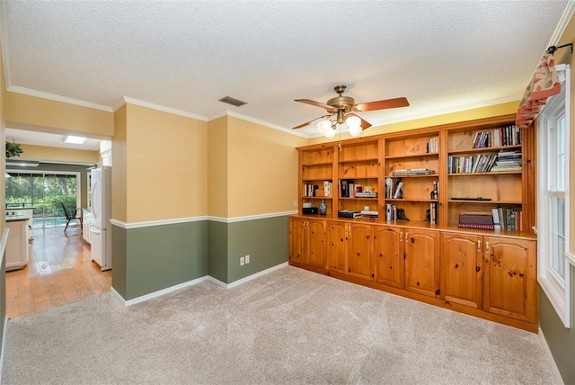 6321 Quarterhorse Cir, Cocoa, FL 32926 - spare room featuring a textured ceiling, light colored carpet, a ceiling fan, crown molding, and baseboards