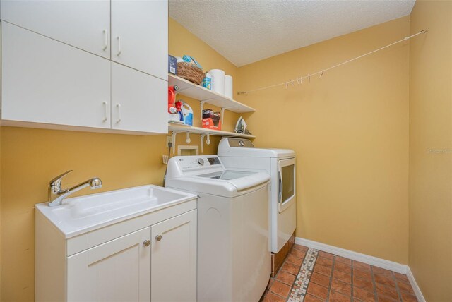 6321 Quarterhorse Cir, Cocoa, FL 32926 - washroom with washer and clothes dryer, cabinet space, baseboards, tile patterned flooring, and a textured ceiling
