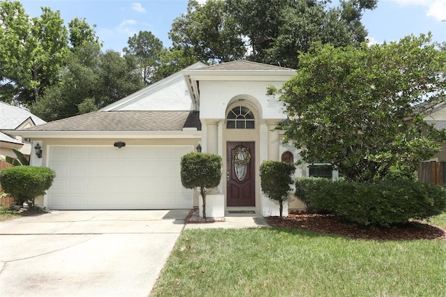5165 Mystic Point Ct, Orlando, FL 32812 - view of front facade featuring an attached garage, concrete driveway, roof with shingles, stucco siding, and a front yard
