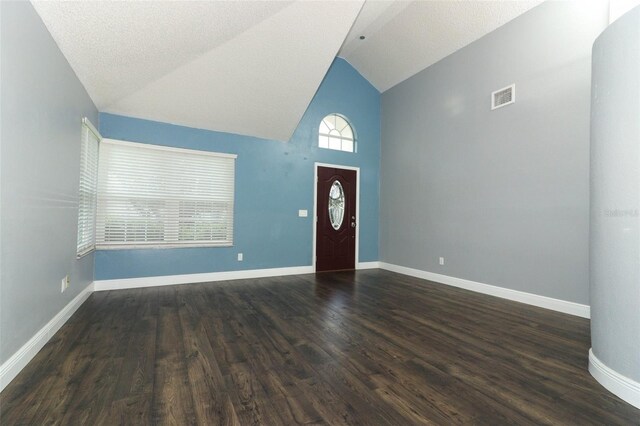5165 Mystic Point Ct, Orlando, FL 32812 - foyer entrance with dark wood-type flooring, baseboards, and high vaulted ceiling