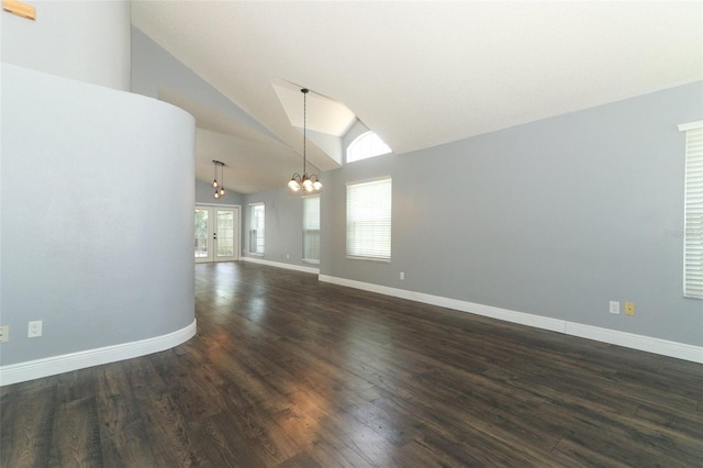 5165 Mystic Point Ct, Orlando, FL 32812 - empty room with a chandelier, dark wood-style flooring, baseboards, and high vaulted ceiling