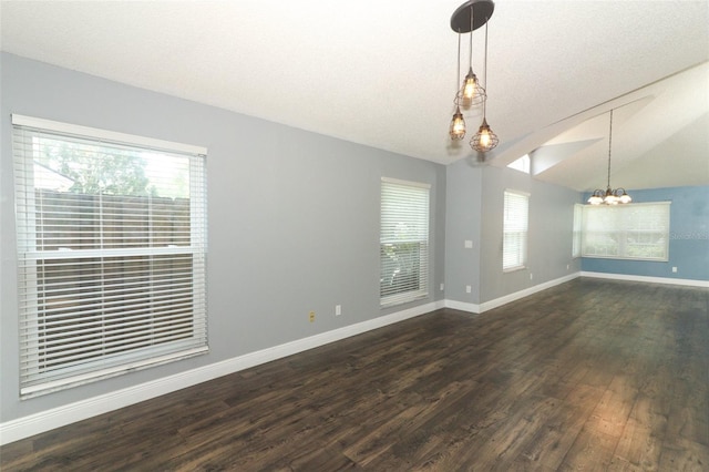 5165 Mystic Point Ct, Orlando, FL 32812 - spare room with a chandelier, dark wood-style floors, plenty of natural light, baseboards, and vaulted ceiling