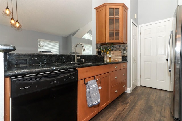 5165 Mystic Point Ct, Orlando, FL 32812 - kitchen with black dishwasher, a sink, brown cabinetry, tasteful backsplash, and vaulted ceiling
