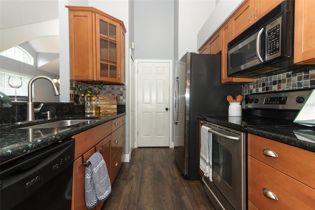 5165 Mystic Point Ct, Orlando, FL 32812 - kitchen featuring stainless steel range with electric cooktop, dishwasher, a sink, brown cabinetry, and dark wood-style flooring