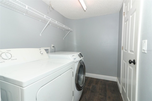 5165 Mystic Point Ct, Orlando, FL 32812 - washroom with washer and dryer, dark wood finished floors, baseboards, and a textured ceiling