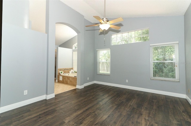 5165 Mystic Point Ct, Orlando, FL 32812 - unfurnished room featuring a ceiling fan, arched walkways, wood finished floors, high vaulted ceiling, and baseboards