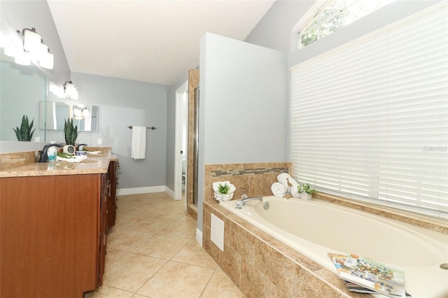 5165 Mystic Point Ct, Orlando, FL 32812 - bathroom featuring vanity, a bath, a shower stall, tile patterned floors, and baseboards