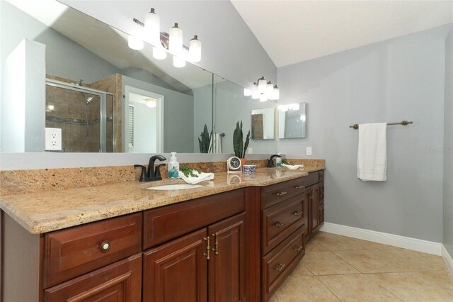 5165 Mystic Point Ct, Orlando, FL 32812 - full bathroom with double vanity, a shower stall, tile patterned floors, baseboards, and lofted ceiling
