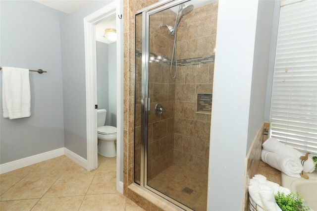 5165 Mystic Point Ct, Orlando, FL 32812 - bathroom with a shower stall, toilet, tile patterned floors, and baseboards