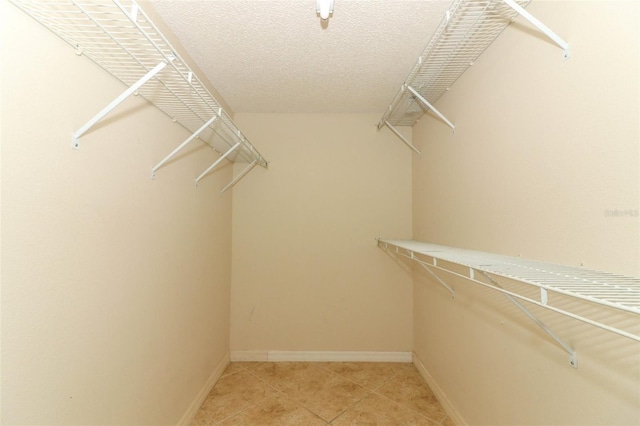 5165 Mystic Point Ct, Orlando, FL 32812 - spacious closet with light tile patterned flooring