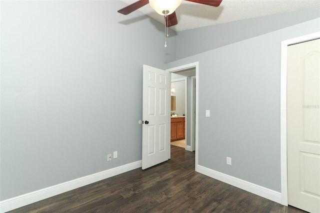 5165 Mystic Point Ct, Orlando, FL 32812 - unfurnished bedroom featuring baseboards, dark wood-style floors, lofted ceiling, and ceiling fan