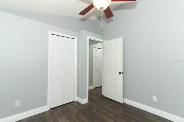 5165 Mystic Point Ct, Orlando, FL 32812 - unfurnished bedroom with baseboards, dark wood-style floors, a closet, lofted ceiling, and ceiling fan
