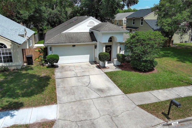 5165 Mystic Point Ct, Orlando, FL 32812 - traditional-style house with an attached garage, a shingled roof, driveway, and stucco siding