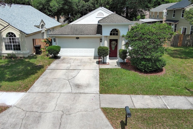 5165 Mystic Point Ct, Orlando, FL 32812 - view of front facade featuring an attached garage, driveway, stucco siding, and a shingled roof