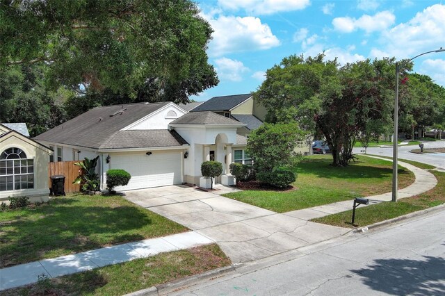 5165 Mystic Point Ct, Orlando, FL 32812 - view of front facade featuring an attached garage, stucco siding, driveway, and a shingled roof